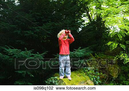 A boy looking through binoculars View Large Photo Image Stock Image - A boy looking through binoculars. Fotosearch