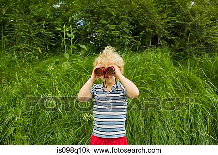 A boy looking through binoculars View Large Photo Image Stock Image - A boy looking through binoculars. Fotosearch