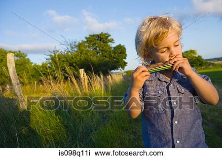 A boy playing the harmonica View Large Photo Image Stock Image - A boy playing the harmonica. Fotosearch