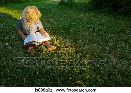 A boy reading a book View Large Photo Image Stock Image - A boy reading a book. Fotosearch