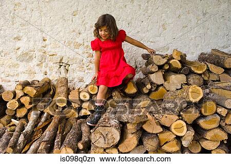 A girl climbing on logs View Large Photo Image Picture - A girl climbing on logs. Fotosearch