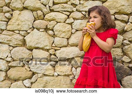 A girl eating a baguette View Large Photo Image Stock Image - A girl eating a baguette. Fotosearch