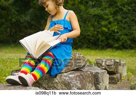 A girl reading a book View Large Photo Image Stock Image - A girl reading a book. Fotosearch