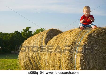 Baby boy sitting on a haystack View Large Photo Image Picture - Baby boy sitting on a haystack. Fotosearch