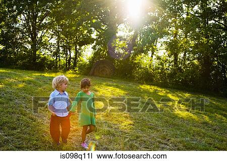 Brother and sister walking hand in hand View Large Photo Image Stock Image - Brother and sister walking hand in hand. Fotosearch