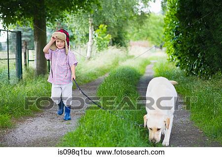 Stock Photograph - A boy walking his dog. Fotosearch