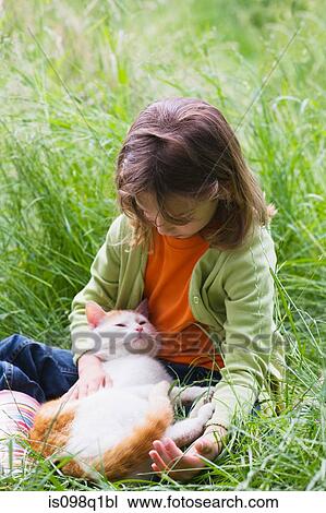 A girl stroking a cat View Large Photo Image Stock Image - A girl stroking a cat. Fotosearch