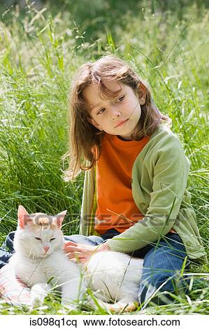 Stock Photography - A girl stroking a cat. Fotosearch