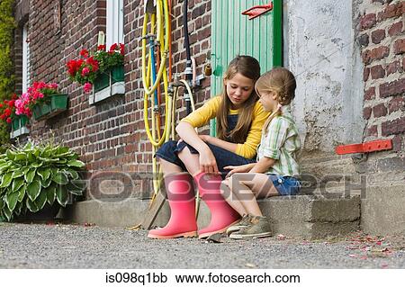 Sisters sitting on a step View Large Photo Image Stock Image - Sisters sitting on a step. Fotosearch