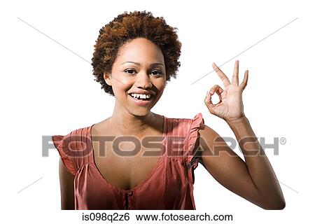 Portrait of young woman giving the ok sign View Large Photo Image Stock Photograph - Portrait of young woman giving the ok sign. Fotosearch