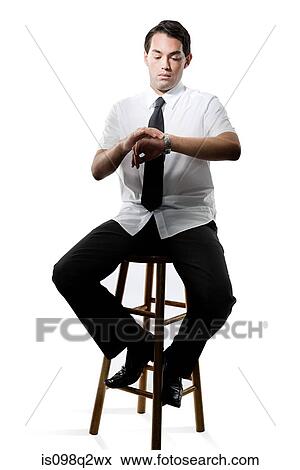 Young man checking his watch View Large Photo Image Stock Photo - Young man checking his watch. Fotosearch