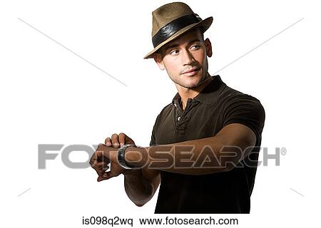 Young man checking his watch View Large Photo Image Stock Photography - Young man checking his watch. Fotosearch