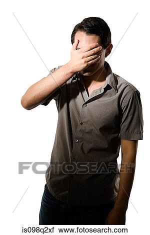 Young man covering his eyes View Large Photo Image Stock Image - Young man covering his eyes. Fotosearch