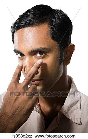 Young man pointing at his eyes View Large Photo Image Stock Photo - Young man pointing at his eyes. Fotosearch
