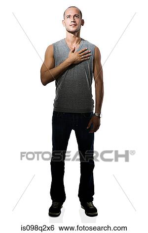 Stock Photograph - Young man with her hand on her chest. Fotosearch