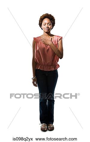 Young woman with her hand on her chest View Large Photo Image Stock Photo - Young woman with her hand on her chest. Fotosearch