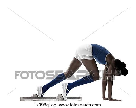 Stock Image - Young woman at starting blocks. Fotosearch