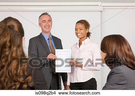 Picture - A lecturer handing a certificate to a student. Fotosearch
