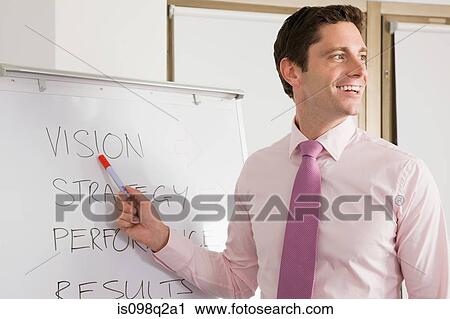 A lecturer pointing at whiteboard View Large Photo Image Stock Image - A lecturer pointing at whiteboard. Fotosearch