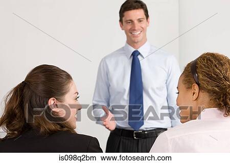 Picture - A lecturer teaching business students. Fotosearch