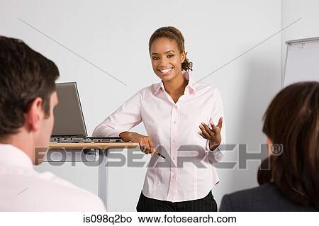 Picture - A lecturer teaching business students. Fotosearch