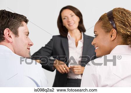 Stock Image - A lecturer teaching business students. Fotosearch