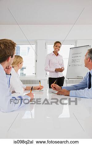 A lecturer teaching business students View Large Photo Image Stock Image - A lecturer teaching business students. Fotosearch