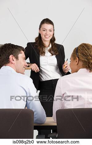 Stock Image - A lecturer teaching business students. Fotosearch