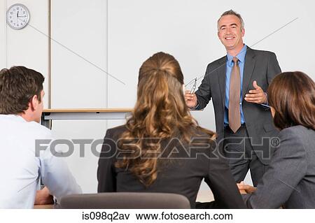 A lecturer teaching business students View Large Photo Image Stock Photo - A lecturer teaching business students. Fotosearch