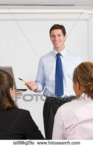 A lecturer teaching business students View Large Photo Image Stock Photograph - A lecturer teaching business students. Fotosearch