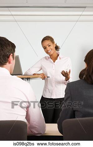 A lecturer teaching business students View Large Photo Image Stock Photograph - A lecturer teaching business students. Fotosearch