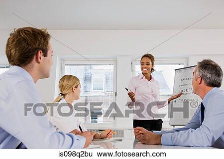 A lecturer teaching business students View Large Photo Image Stock Photograph - A lecturer teaching business students. Fotosearch