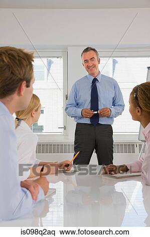 A lecturer teaching business students View Large Photo Image Stock Photography - A lecturer teaching business students. Fotosearch