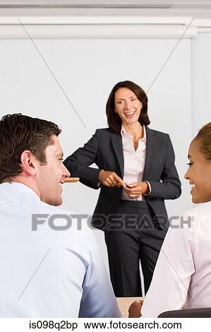 A lecturer teaching business students View Large Photo Image Stock Photography - A lecturer teaching business students. Fotosearch