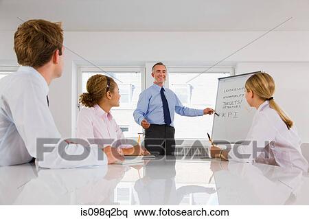 A lecturer teaching business students View Large Photo Image Stock Photography - A lecturer teaching business students. Fotosearch