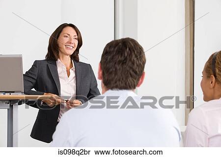 Stock Photography - A lecturer teaching business students. Fotosearch