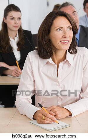 Stock Photograph - Business students in a lesson. Fotosearch