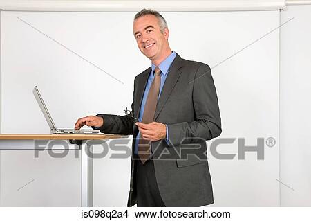 Portrait of a lecturer using a laptop View Large Photo Image Picture - Portrait of a lecturer using a laptop. Fotosearch