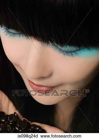 Stock Image - Woman smelling coffee beans. Fotosearch