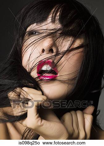 Picture - Woman with hair over her face. Fotosearch