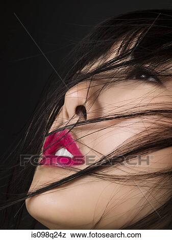 Stock Photo - Woman with hair over her face. Fotosearch