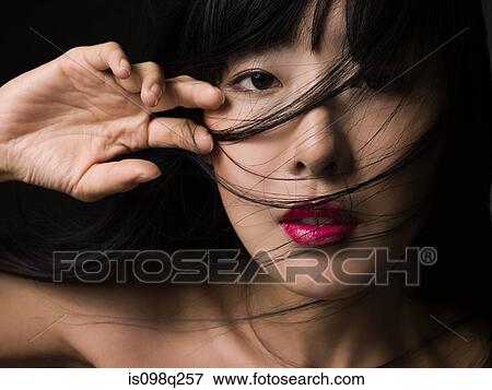 Woman with hair over her face View Large Photo Image Stock Photo - Woman with hair over her face. Fotosearch