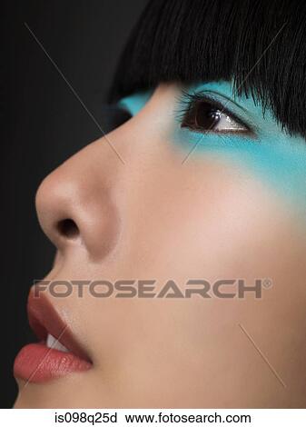 Stock Image - Woman with turquoise eyeshadow. Fotosearch