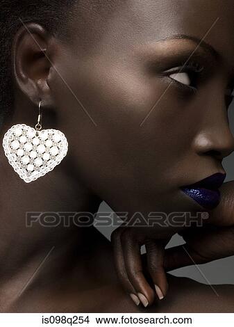 Young woman wearing earring View Large Photo Image Picture - Young woman wearing earring. Fotosearch