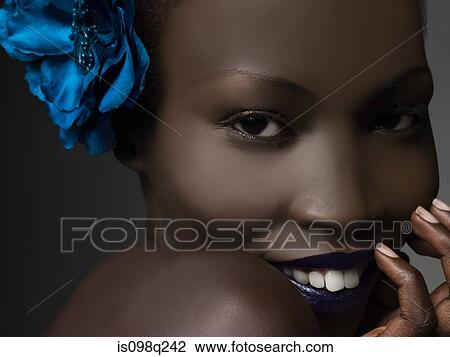 Stock Image - Young woman wearing flower. Fotosearch