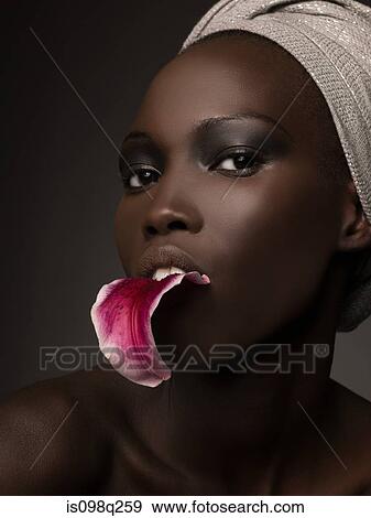 Young woman with petal in her mouth View Large Photo Image Stock Photo - Young woman with petal in her mouth. Fotosearch