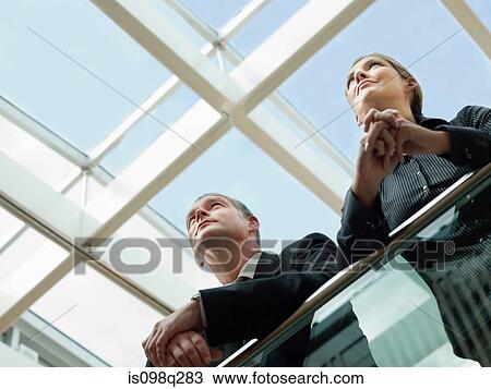 Stock Image - Colleagues looking up. Fotosearch