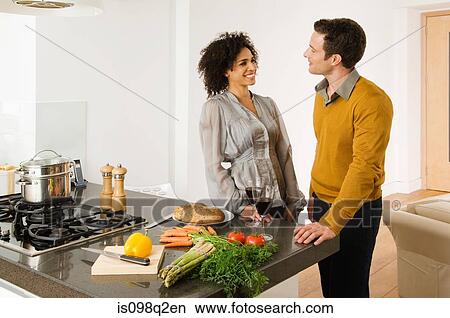 Picture - A man and woman having red wine. Fotosearch