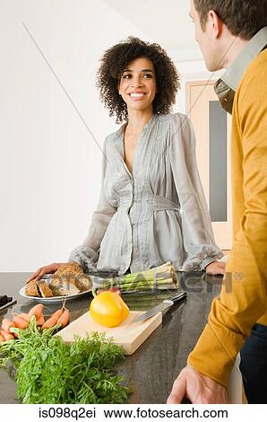 Stock Image - A man and woman in a kitchen. Fotosearch