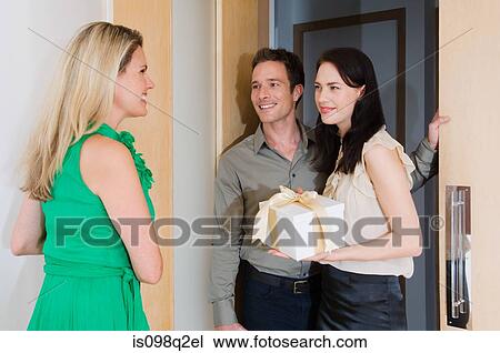 A woman greeting friends at the door View Large Photo Image Stock Image - A woman greeting friends at the door. Fotosearch
